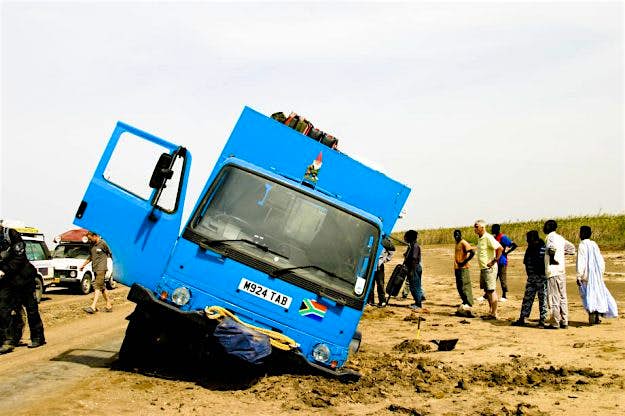 Travel News - africa-trip-11 The truck broke through the boggy clay marshland near Senegal and was dug out by members of the Amsterdam Dakar Rally.
