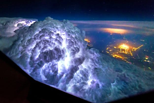 Travel News - HEAVENLY WEATHER FROM A PLANE Thunderstorms light up the insides of cloud formations.