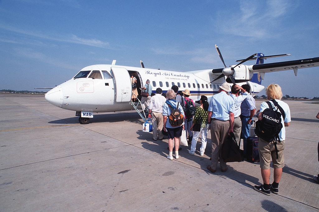 People standing in line to board a plane