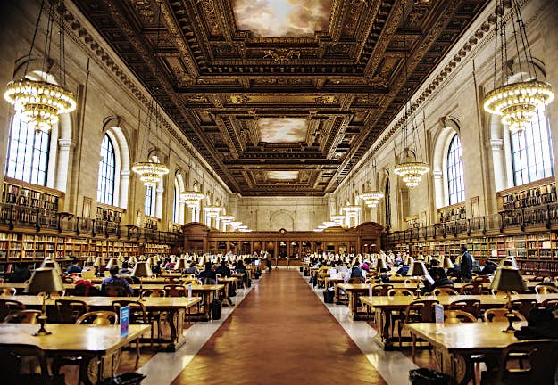 Travel News - gettyimages-495288115 People studying in the Main Reading room in the New York Public Library, Manhattan, New York City, New York.
