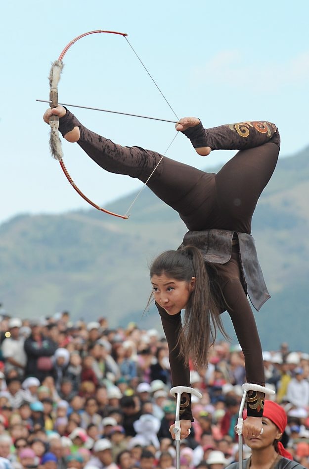 A girl in traditional dress perform and impressive display at the World Nomad Games. 
