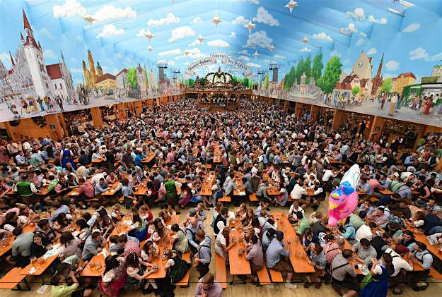 Travel News - Oktoberfest Visitors sit in a festival tent of the Oktoberfest beer festival at the Theresienwiese in Munich.