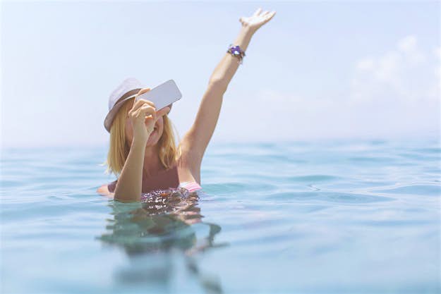 Travel News - gettyimages-511220673 Teenager takes selfies in the sea.