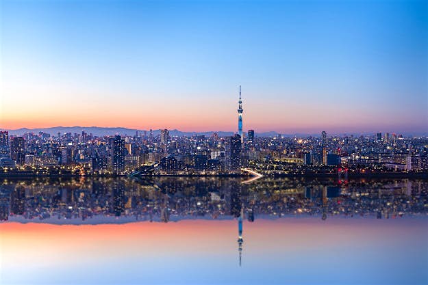 Travel News - GettyImages-581560107 Cityscrape waterfront reflection image of Tokyo with skyscrapers and Tokyo Sky tree illuminated, Tokyo, Japan.