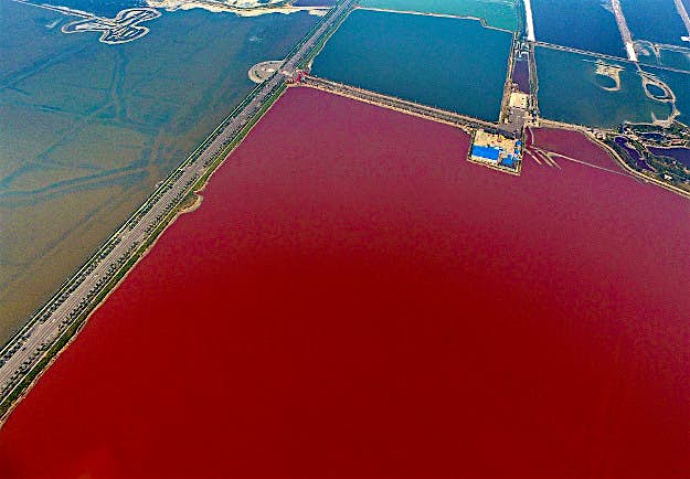 Travel News - gettyimages-611948468 Aerial view of the colorful salt lake on October 2, 2016 in Yuncheng, Shanxi Province of China. The salt lake displaying red and green colors in Yuncheng attract tourists during the National Day holiday. Formed about 500 million years ago, the salt lake owns different colors as a result of the algae in the water.
