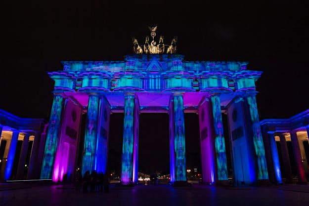 Travel News - GERMANY-ART-FESTIVAL-LANDMARK Dark blue and purple lights illuminate the Brandenburg Gate.