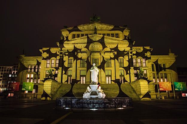Travel News - GERMANY-ART-FESTIVAL-LANDMARK Yellow designs are projected on the facade of the Berlin Concert Hall (Konzerthaus) on the Gendarmenmark.