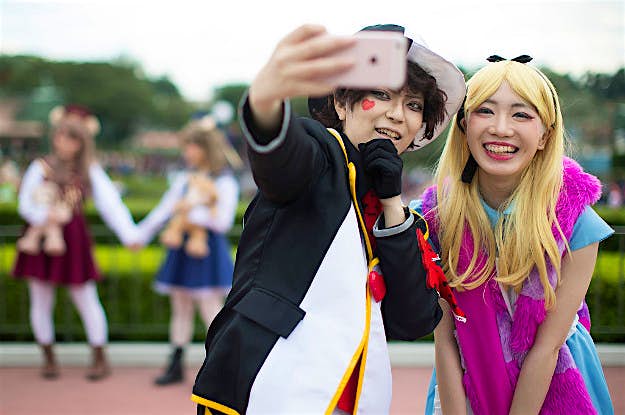 Travel News - gettyimages-617861508-1 Visitors dressed as Disney characters pose for a photograph during the Disney's Halloween 2016 event.