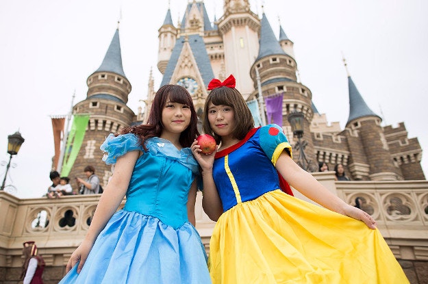 Visitors dressed as Disney characters pose for a photograph during the Disney's Halloween 2016 event. 