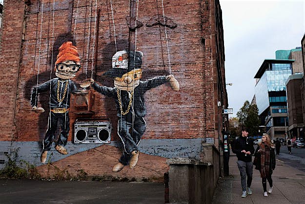Travel News - <> on October 26, 2016 in Glasgow, Scotland. Students walk past a mural in John Street.