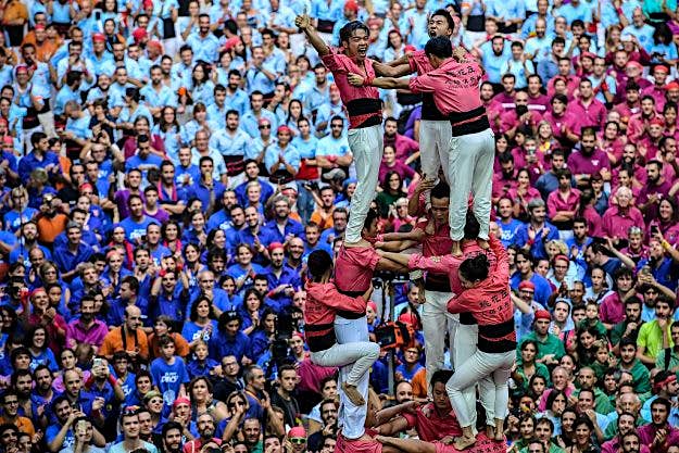 Travel News - Human Towers Are Built In The Tarragona Castells Competition Members of the colla 'Xiquets de Hanghzou' celebrate after building a human tower