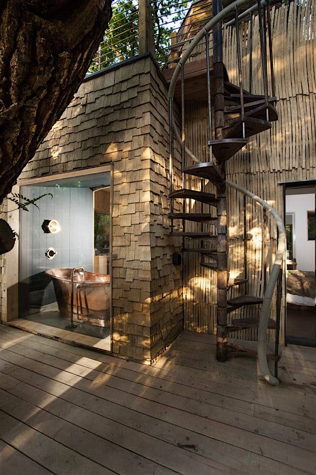 Travel News - 1-9craftycamping-thewoodsmanstreehouse-deck-spiral-stairs Wood working courses are also available for guests to take part in while on site.
