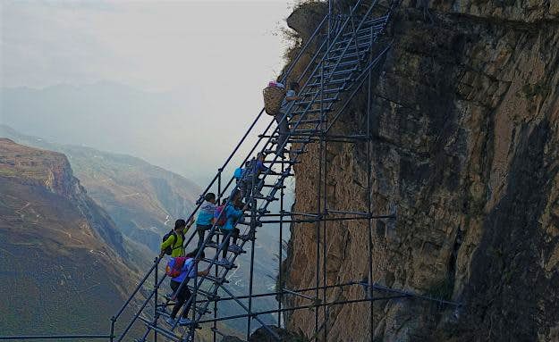Travel News - #¶À¼Ò£ºÌìÌÝ A steel ladder creates a safer path for cliff village children in China. Image: imaginechina