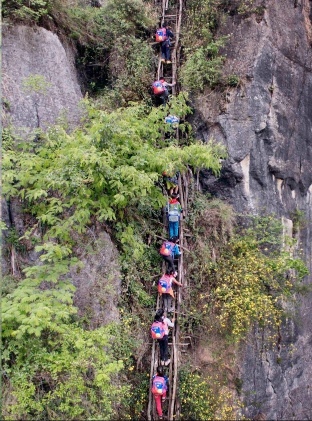 A steel ladder creates a safer path for cliff village children in China. Image: imaginechina