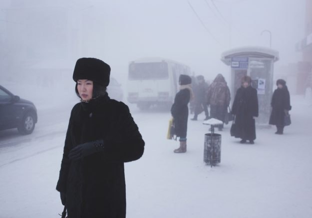 A Yakutian woman in the city centre. Steam from factories, cars and people creates a thick fog in winter which lingers through the coldest weeks.