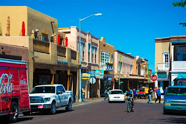 Travel News - Street Scene in Downtown Santa Fe Downtown Santa Fe with Pueblo style storefronts.