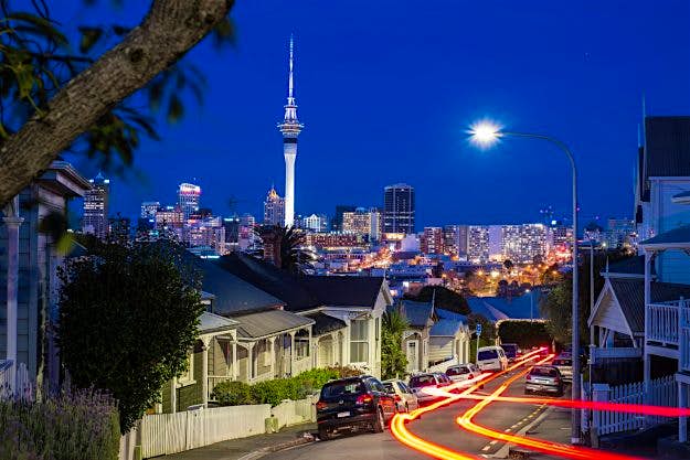 Travel News - Night in Ponsonby Auckland city at dusk with the Sky Tower in the background. Image: Jose Antonio Maciel/Getty Images