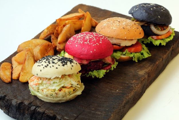 These white, pink and black burger buns from Barcelos in Delhi are part of a trend for colourful burgers. Image: Barcelos