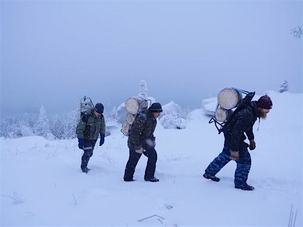 Travel News - Buddhist novices carrying firewood up to the monastery. Buddhist novices carry firewood up to the monastery.
