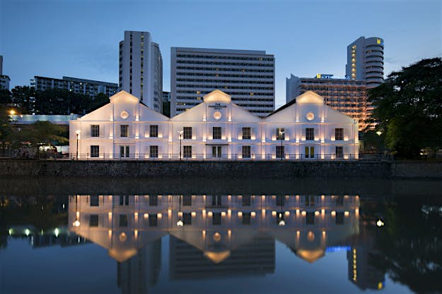 Travel News - The Warehouse Hotel_Evening Facade Straight_High Res The new hotel is built inside of a warehouse.