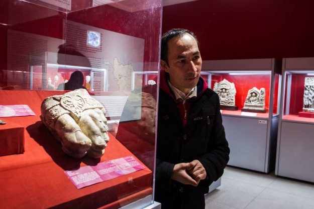 Ghulam Ali Mohseni , curator of Numismatic at the National Museum stands by the foot of Zeus artefact.