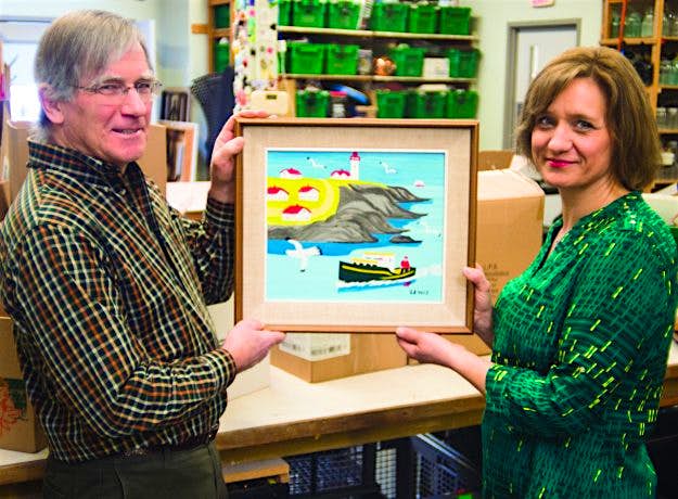 Travel News - Maud_lewis_event (1) Volunteer Louis Silcox and General Manager Karla Richards display the original Maud Lewis painting discovered at the New Hamburg Thrift Centre. Image: MCC Photo/Ken Ogasawara
