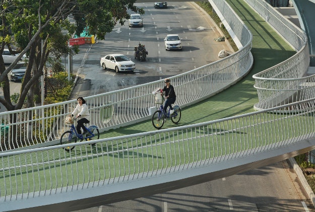 Cyclists ride on China's first elevated bicycle track constructed above the ground in Xiamen city, southeast China's Fujian province, 23 January 2017.