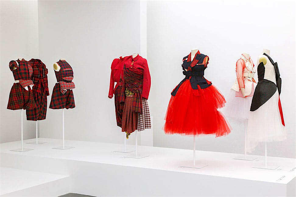 Travel News - Rei Kawakubo dresses Red check and red tulle dresses on display.