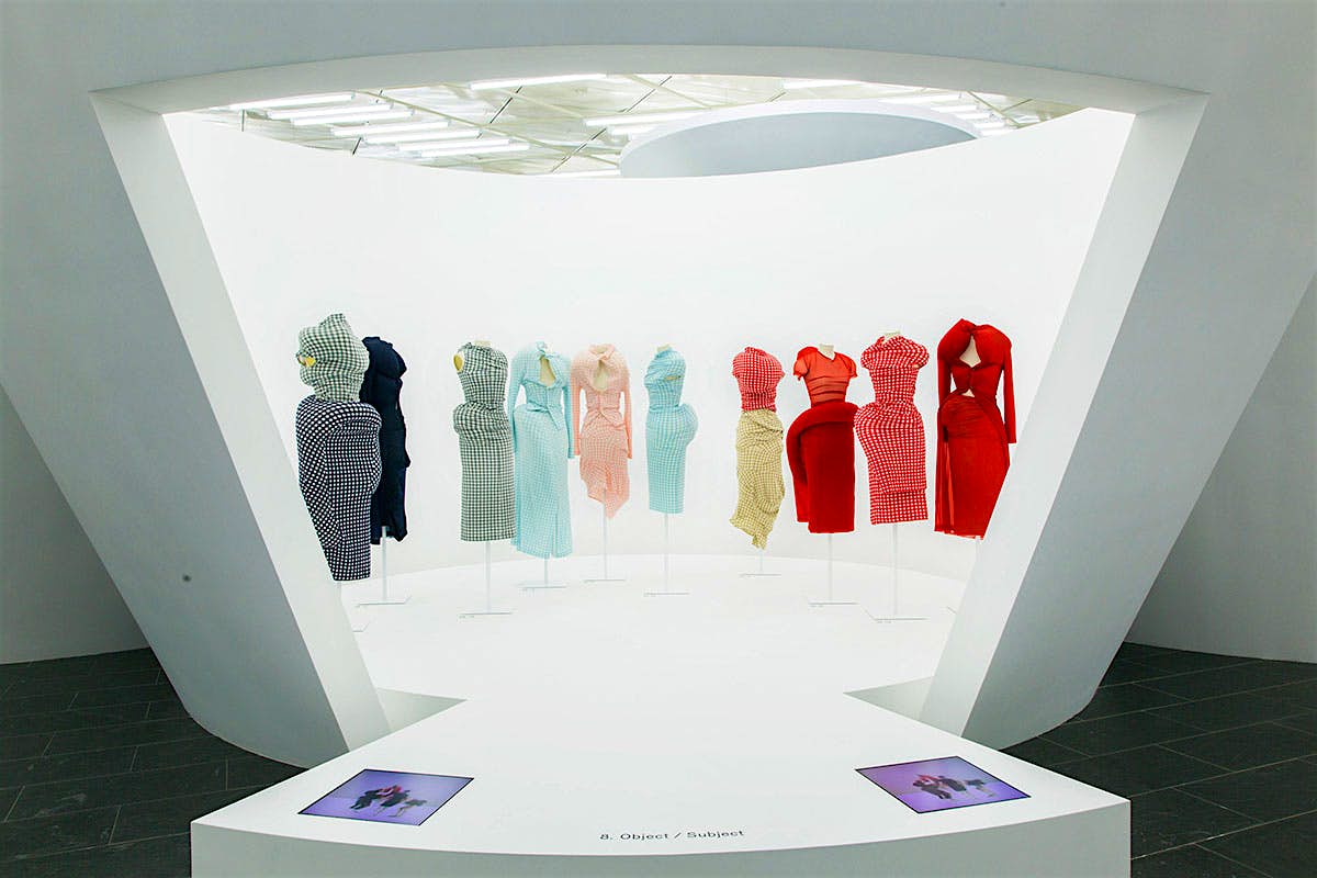 Travel News - Comme des Garcons Met Navy, blue pink and red dresses on mannequins.