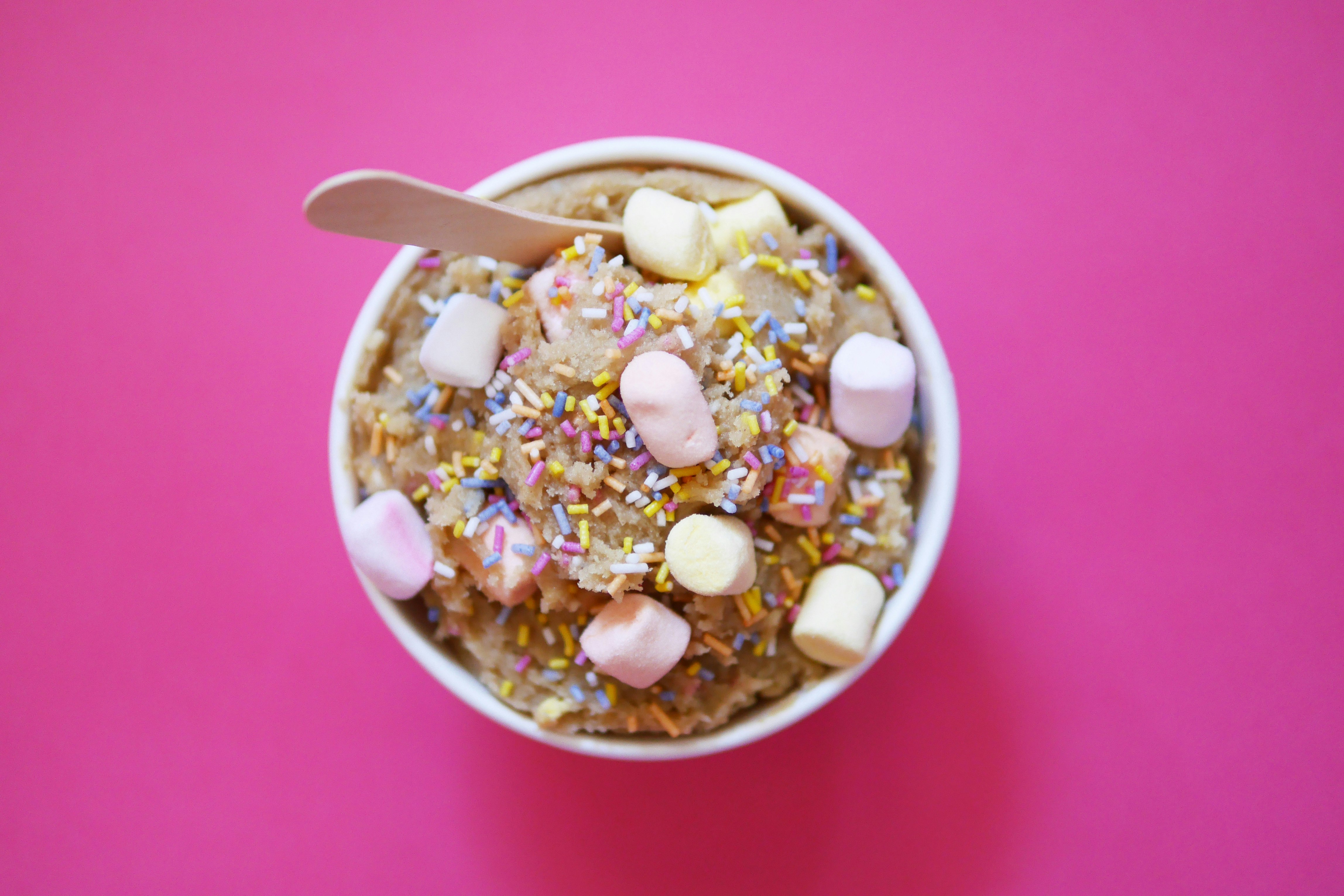 sprinkles and marshmallows on top of cookie dough made by naked dough, London's first cookie dough pop-up