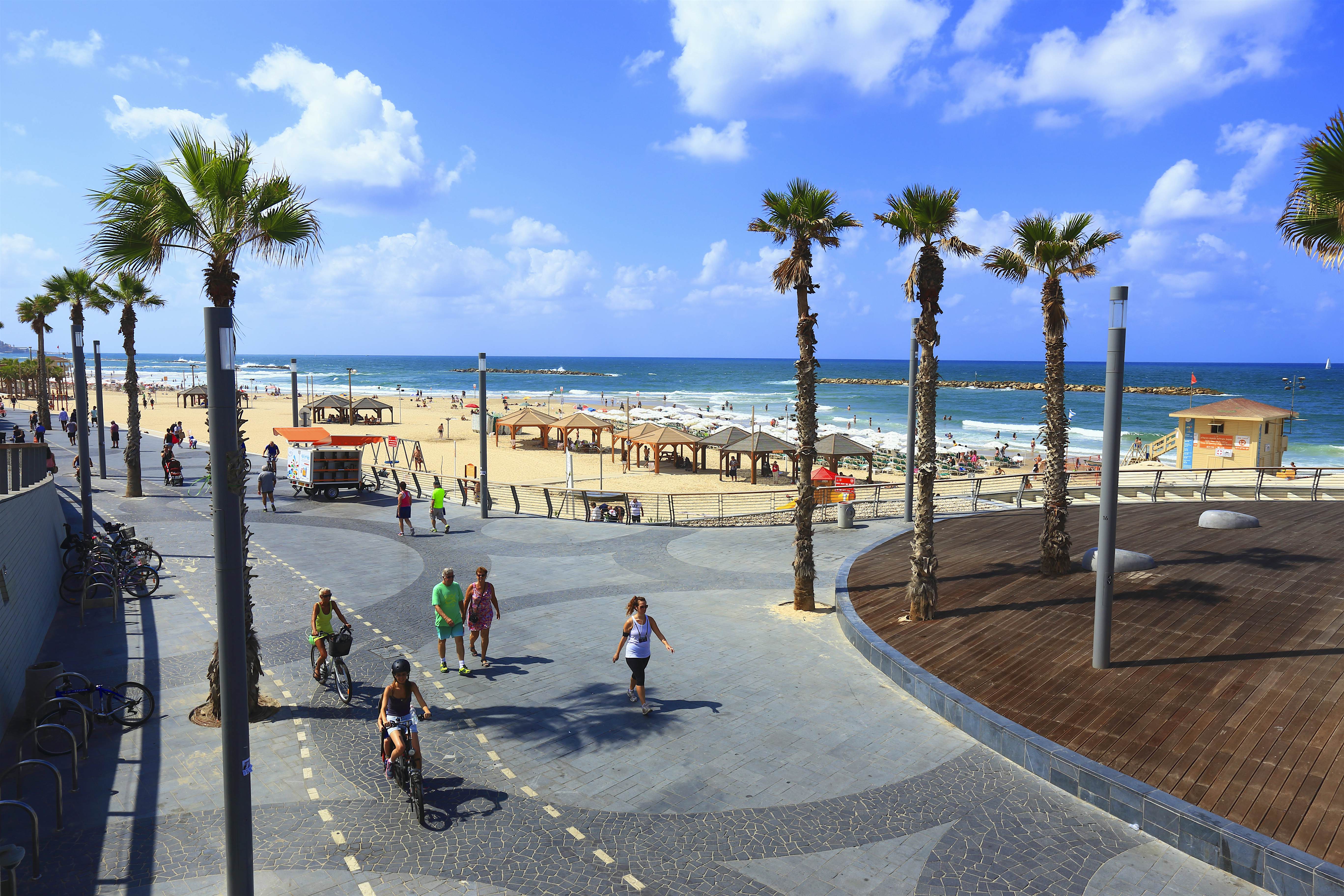 Travel News - The Shlomo Lahat promenade People cycling and walk down a beach promenade in Tel Aviv, Israel.