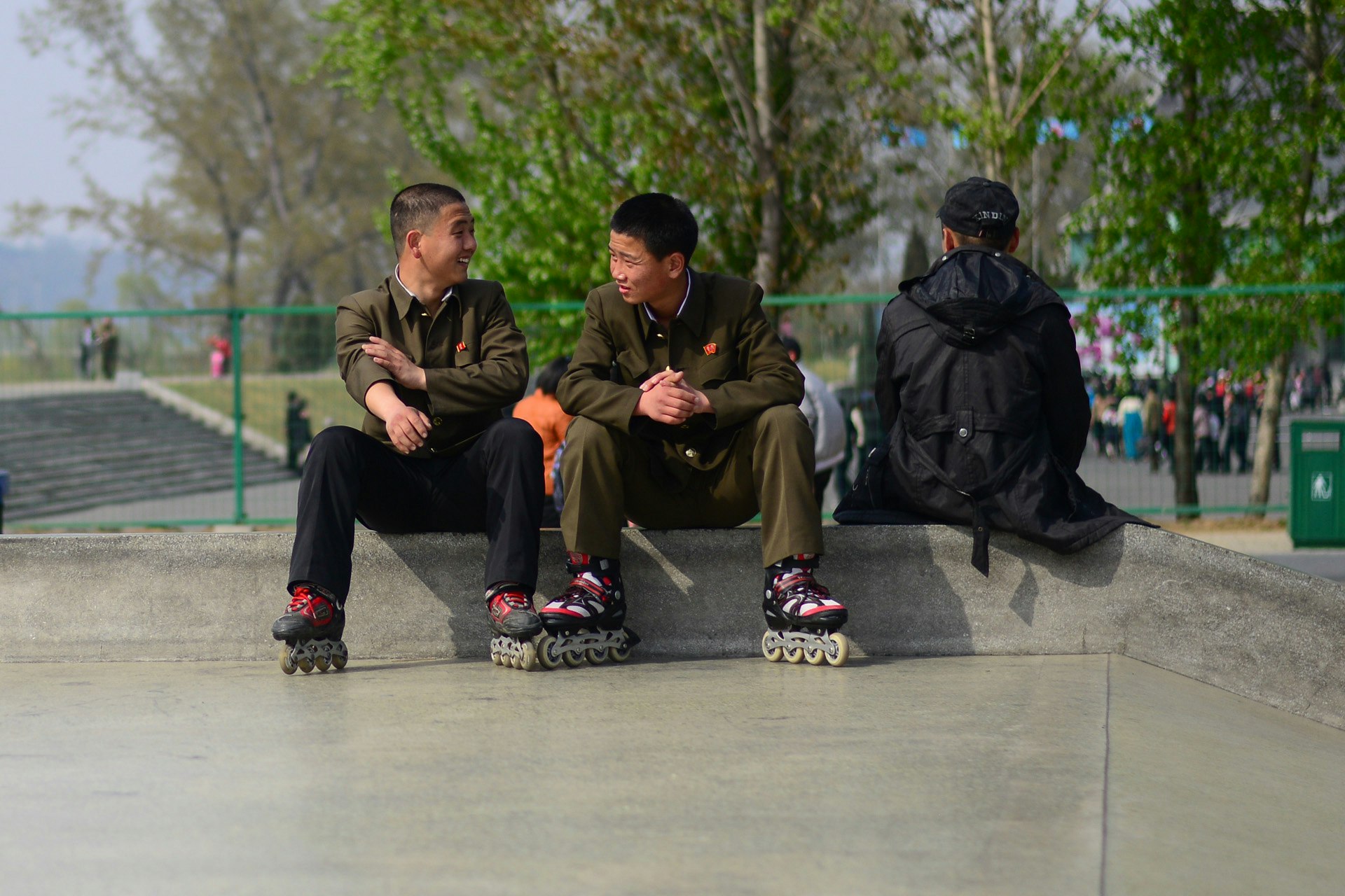 North Korean teenagers chat at a skate park.
