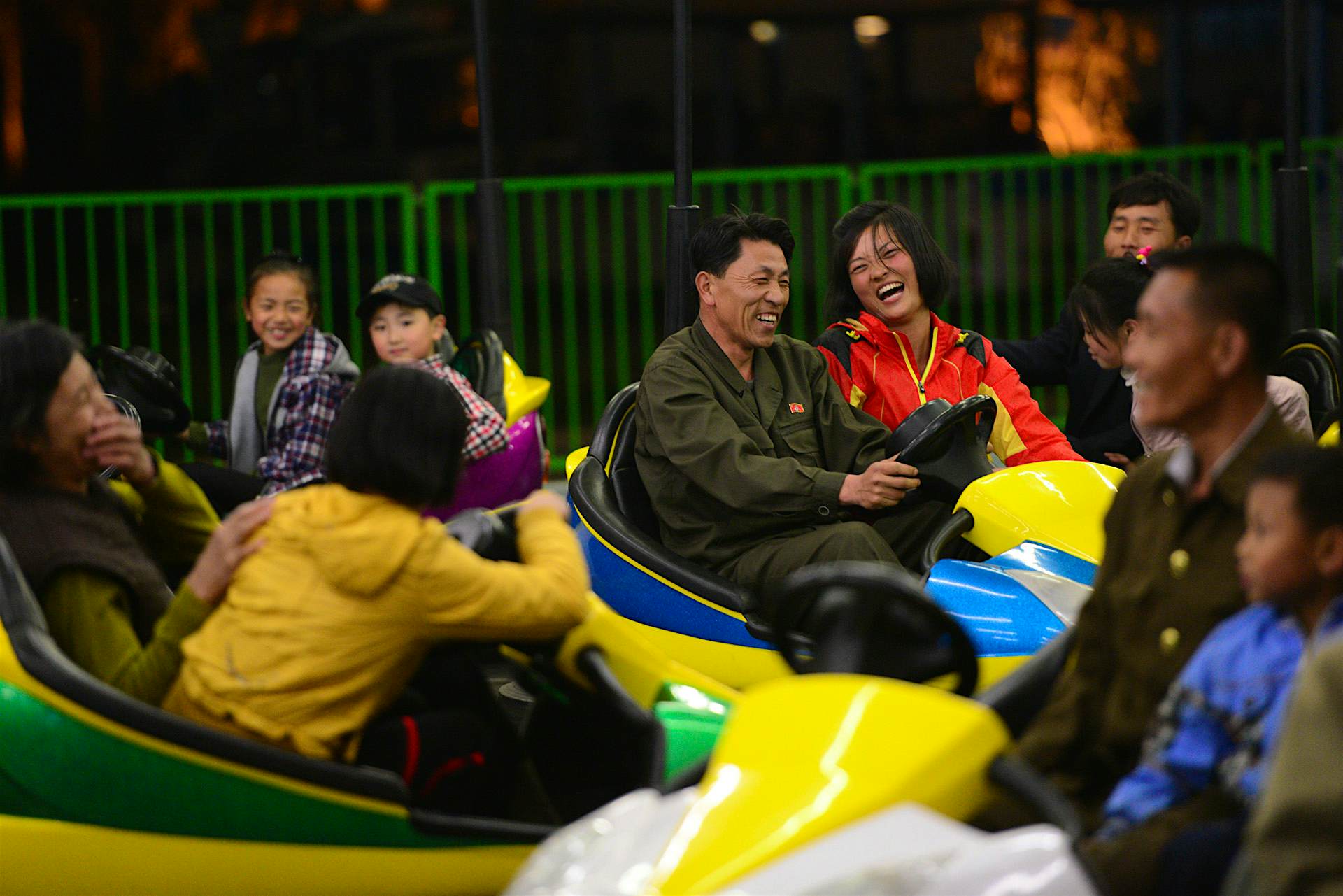 Travel News - Inside North Korea Two people share a laugh at the Pyongyang Amusement park, which featured bumper cars, a roller coaster and other rides.