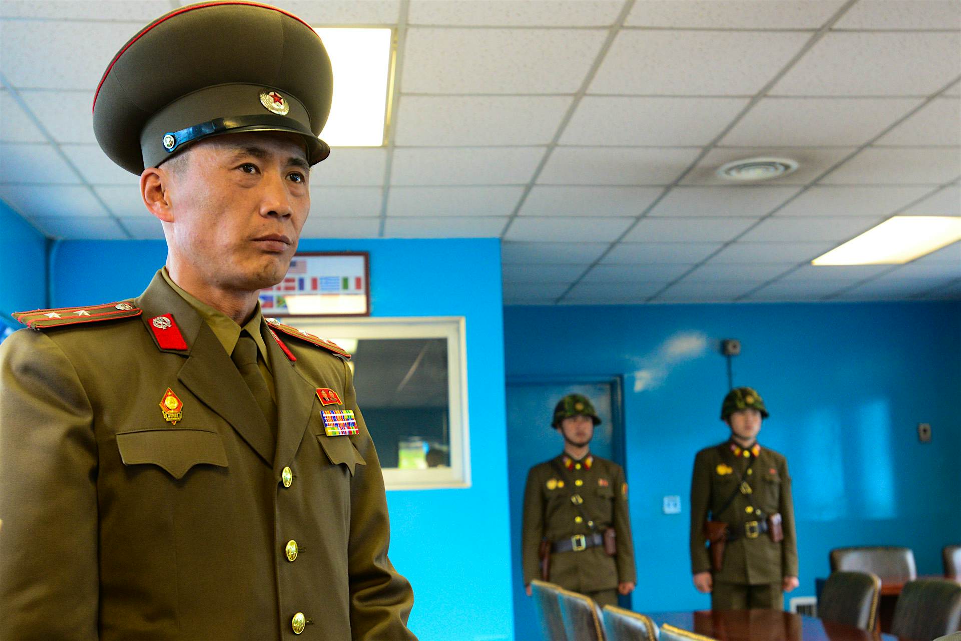 Travel News - Inside North Korea A North Korean officer and soliders stand guard at the old negotiation room at the De-Militarized Zone on the border with South Korea.
