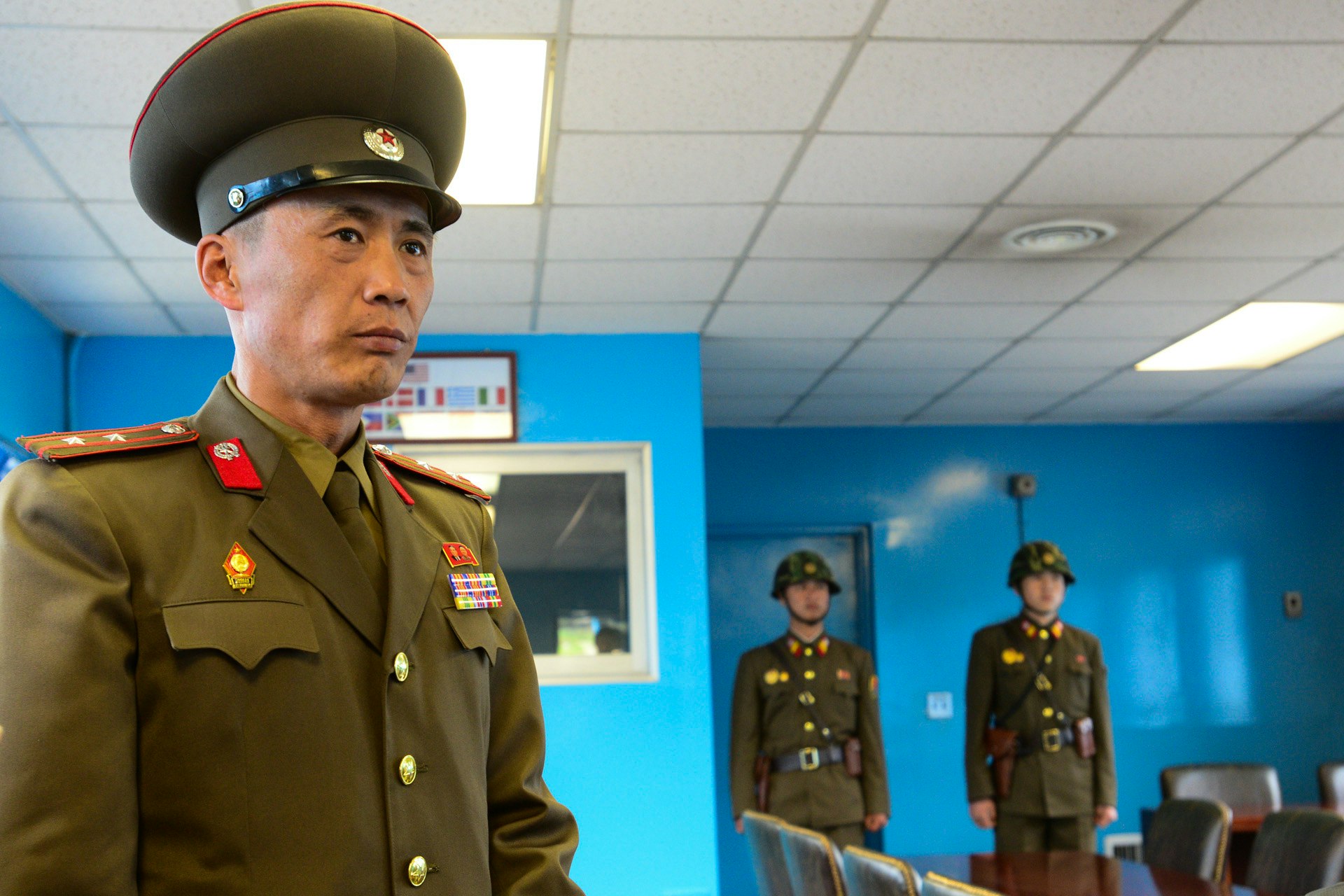 A North Korean officer and soliders stand guard at the old negotiation room at the De-Militarized Zone on the border with South Korea.