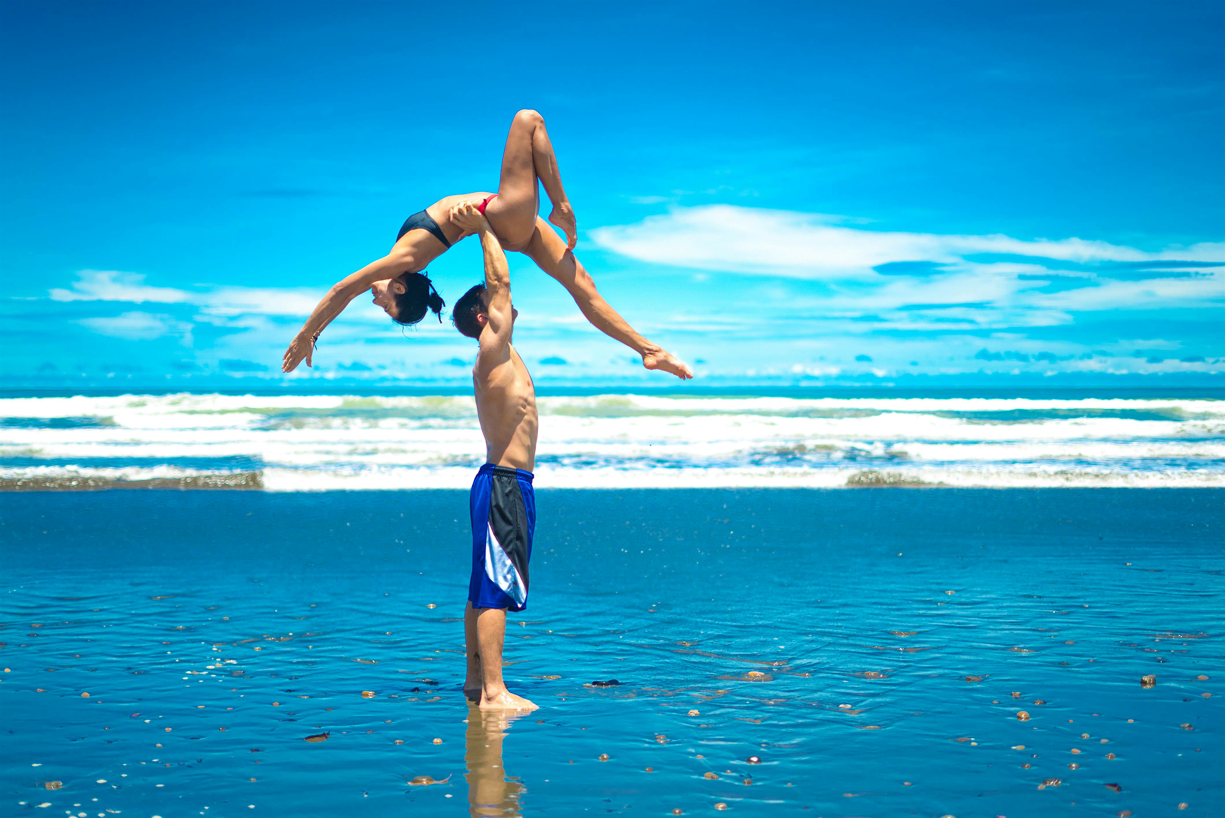 Travel News - Yoga Couple The incredible pictures show the husband and wife team balancing on each other to pull some impressive shapes on the beach.