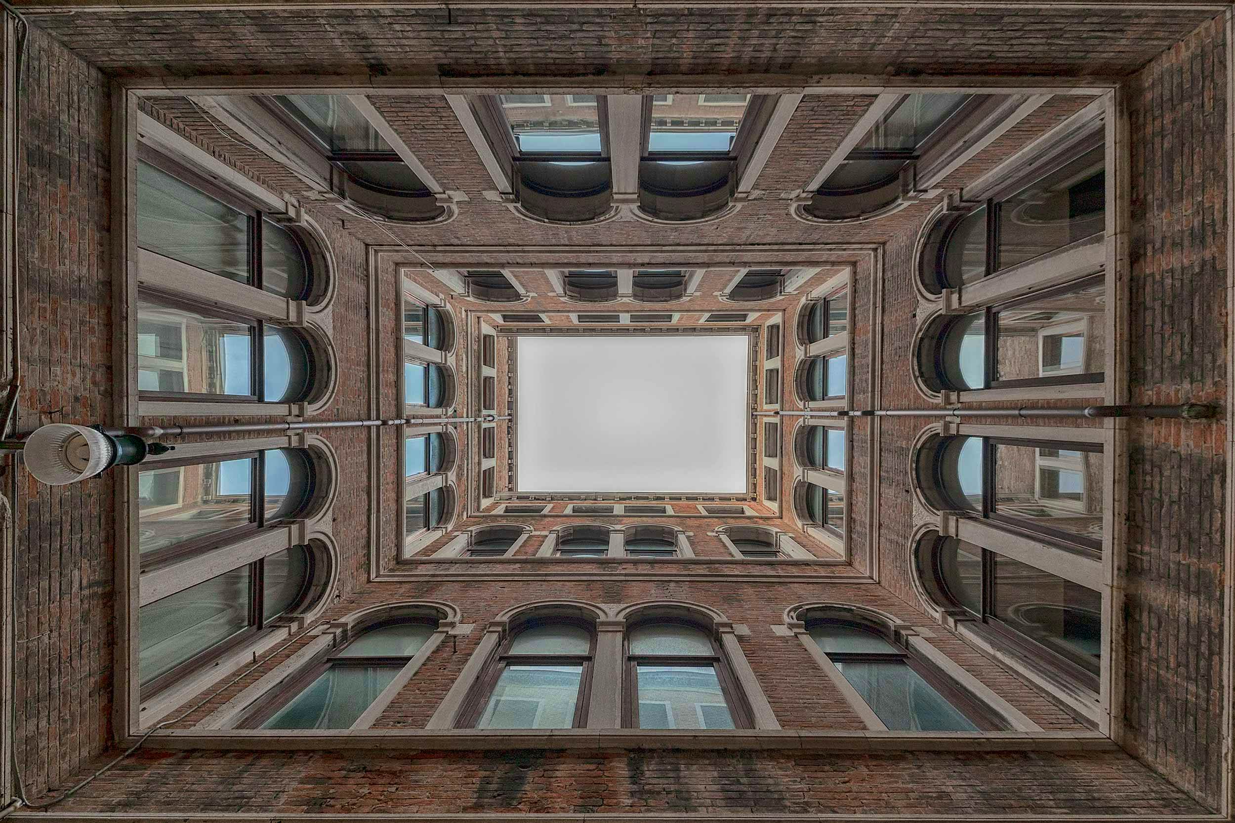 Travel News - Tunnels to the sky seth vane photography travel Venice A symmetrical courtyard and sky in Venice, Italy.