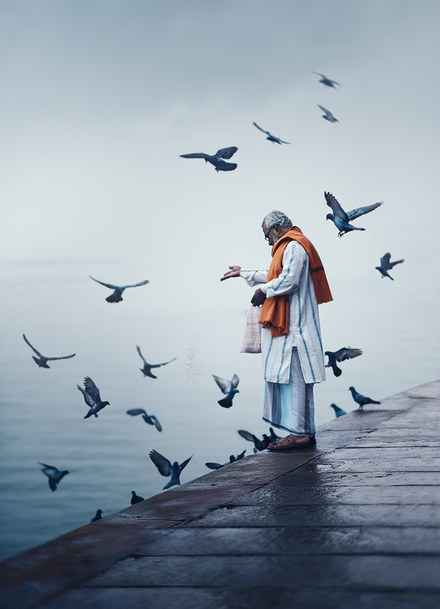 Man feeing birds in Varanasi