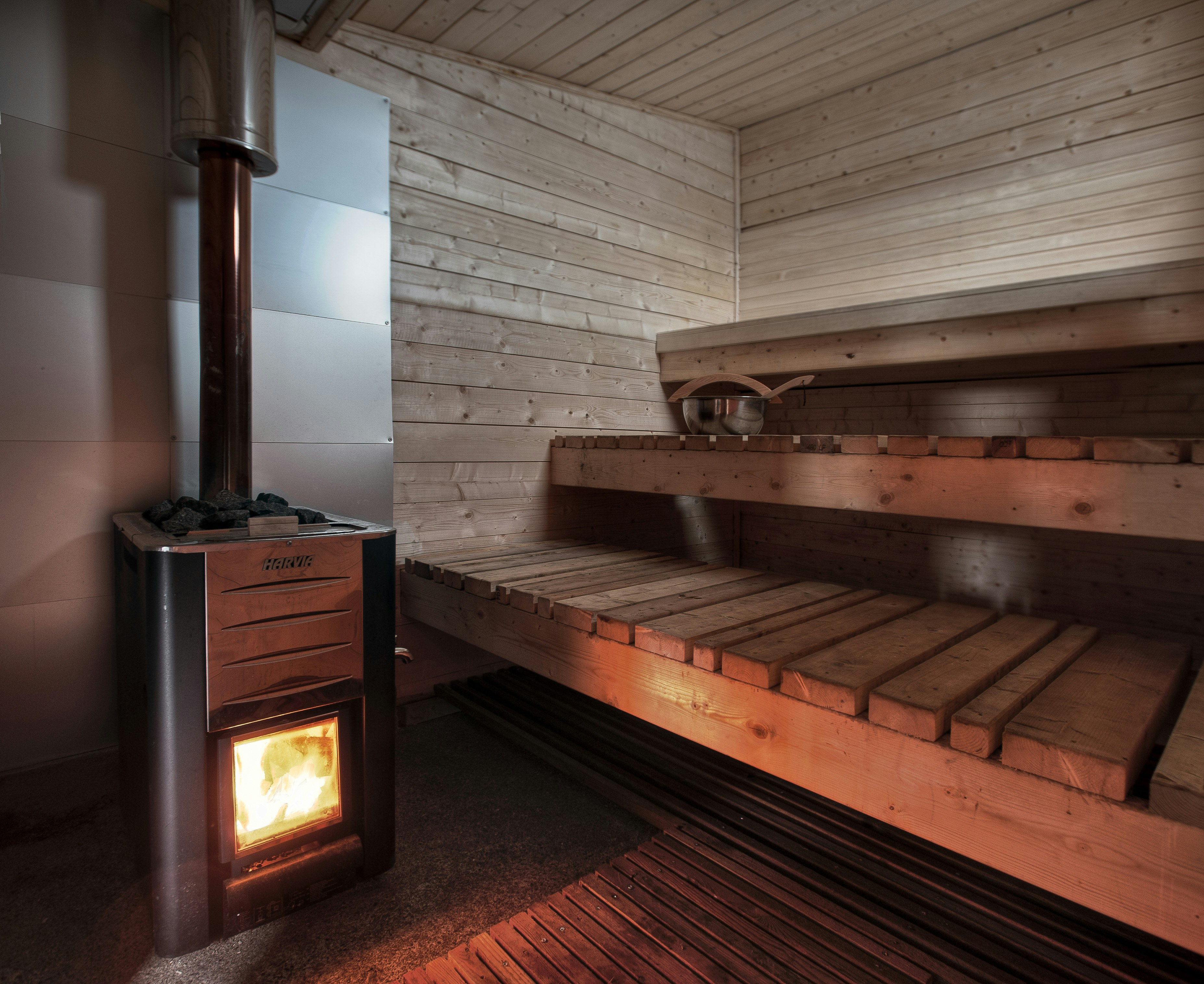 Guests take turns at lighting the sauna room stove