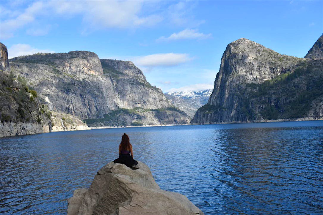 Travel News - We live here now Incredible images show Emily (26) sitting overlooking a shimmering lake.