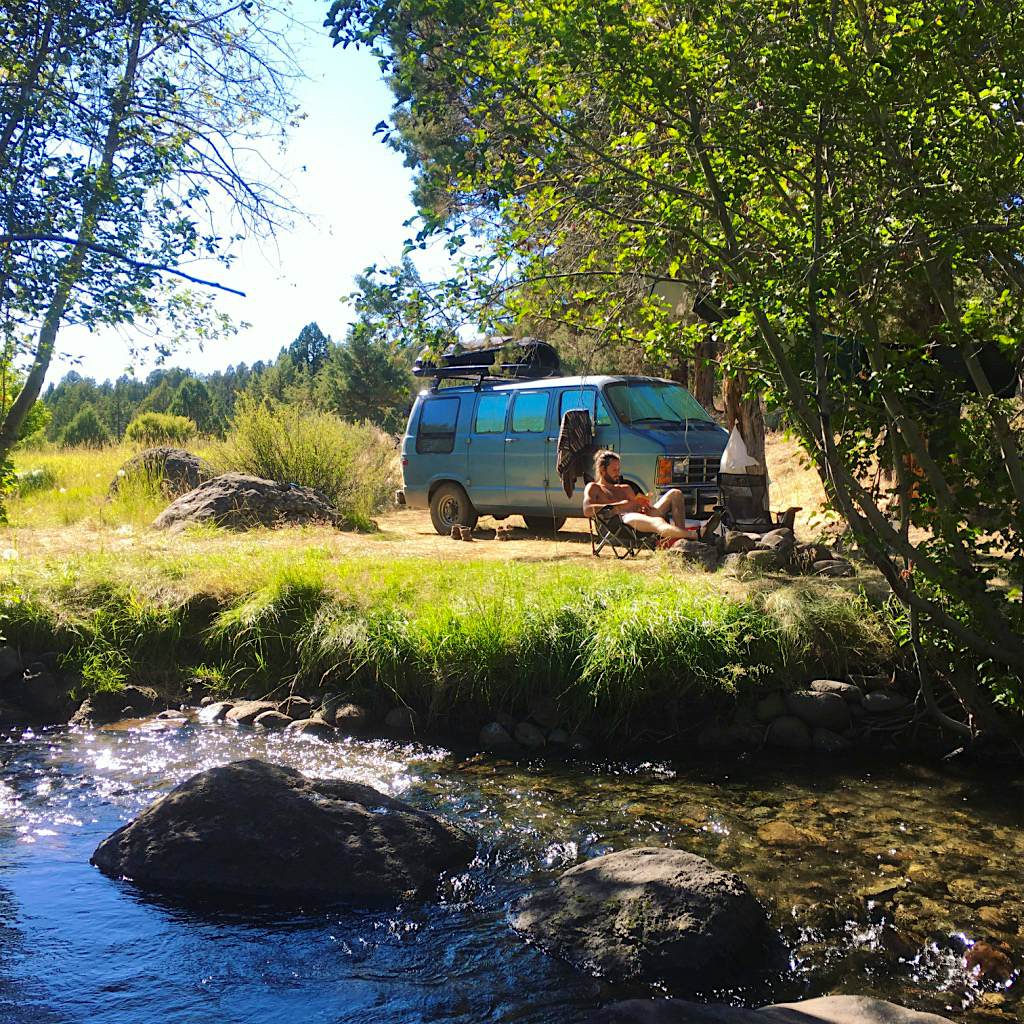 Travel News - We live here now The couple relaxing outside their van.