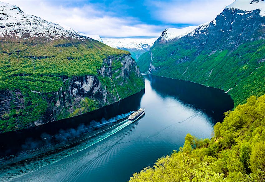 Travel News - shutterstock_309014675 A cruise ship passes through Geiranger fjord in Norway.