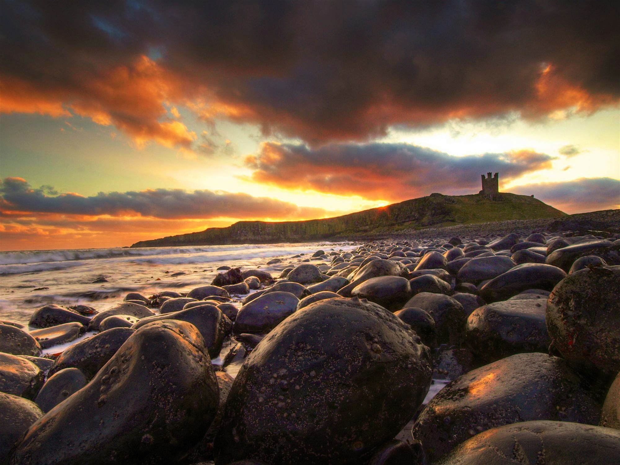 Travel News - Cannon ball beach Dunstanburgh Castle