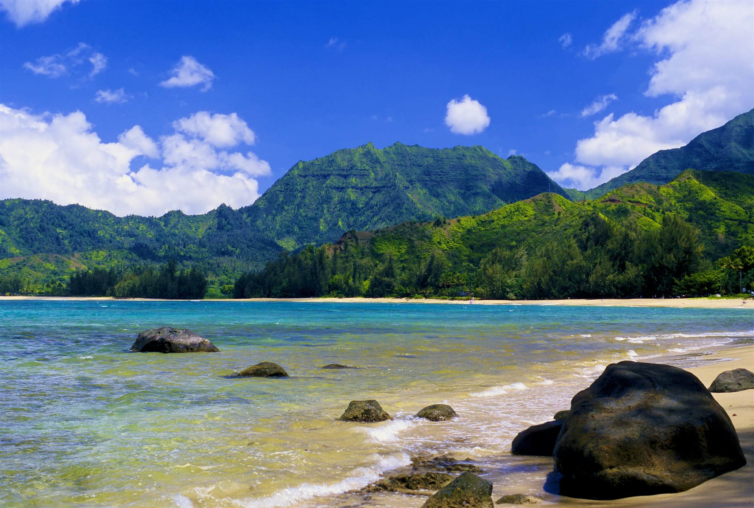 Travel News - Hanalei Bay Beach Spectacular Hanalei Bay is located on the north shore of Kauai, Hawaii.