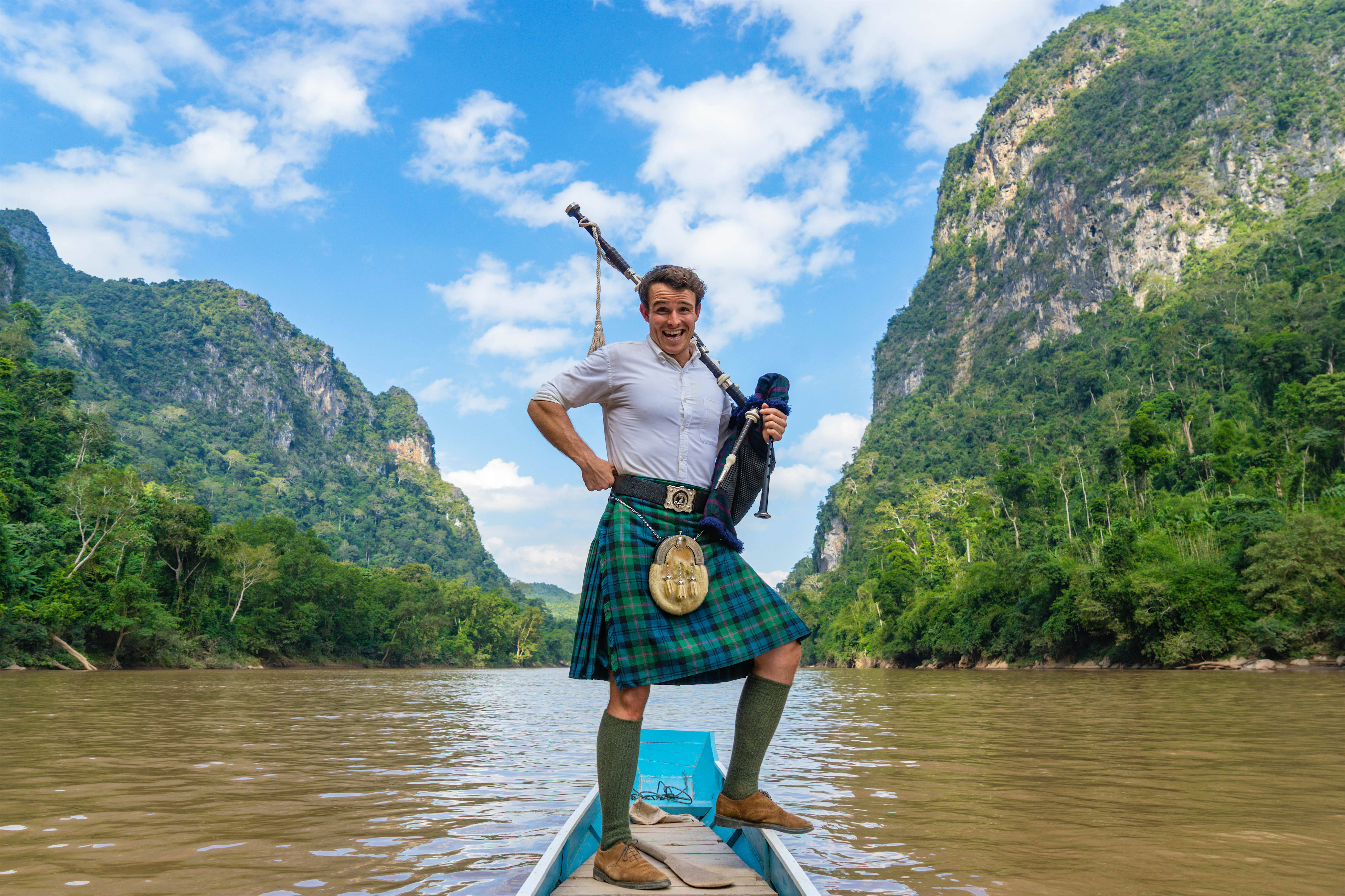 Travel News - The First Piper world travel Ross OC Jennings Lonely Planet river Ross aboard a boat in Muang Ngoy, Laos.