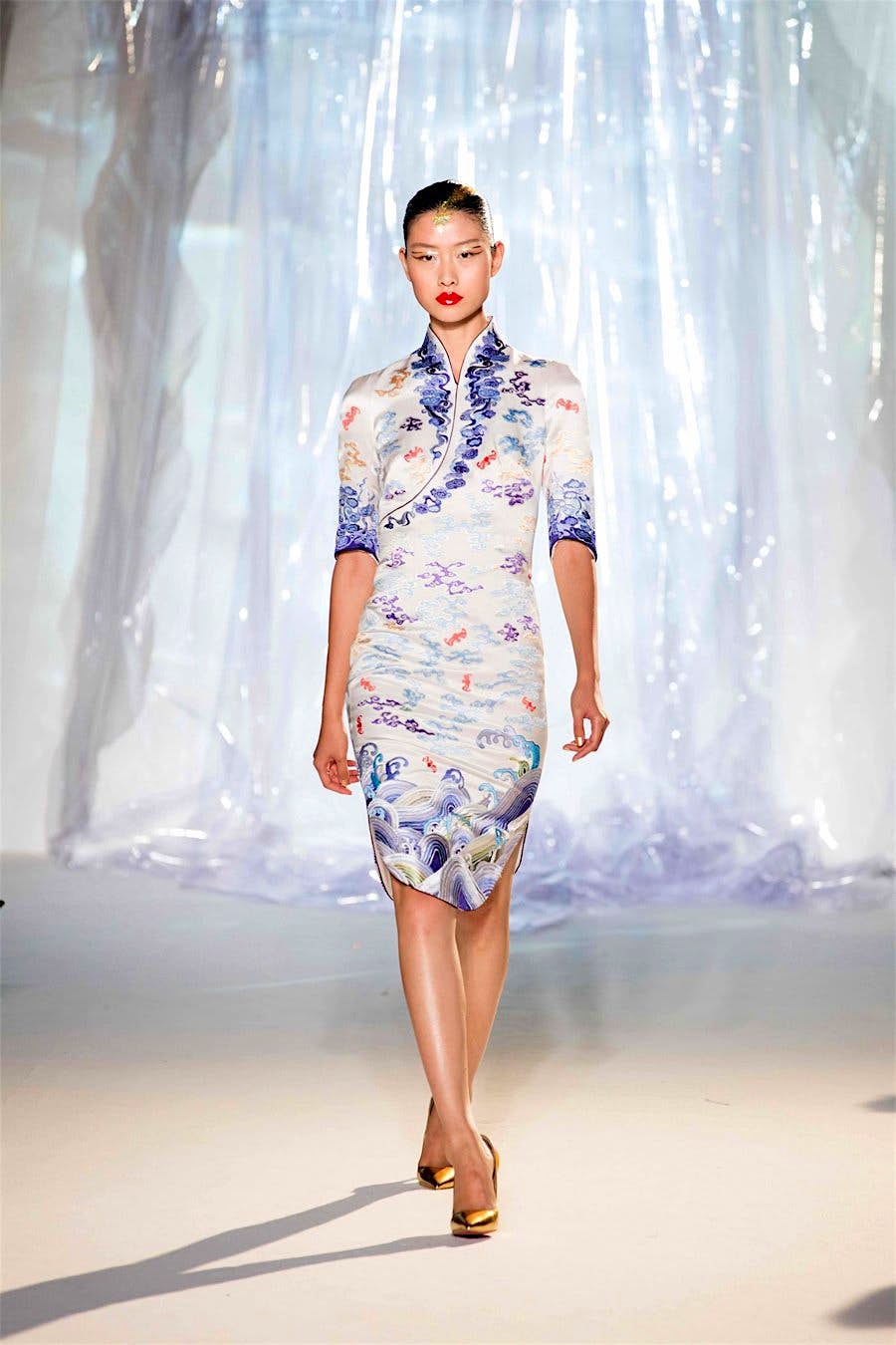 Travel News - flight attendant A woman walks the runway in a Hainan Airlines uniform.