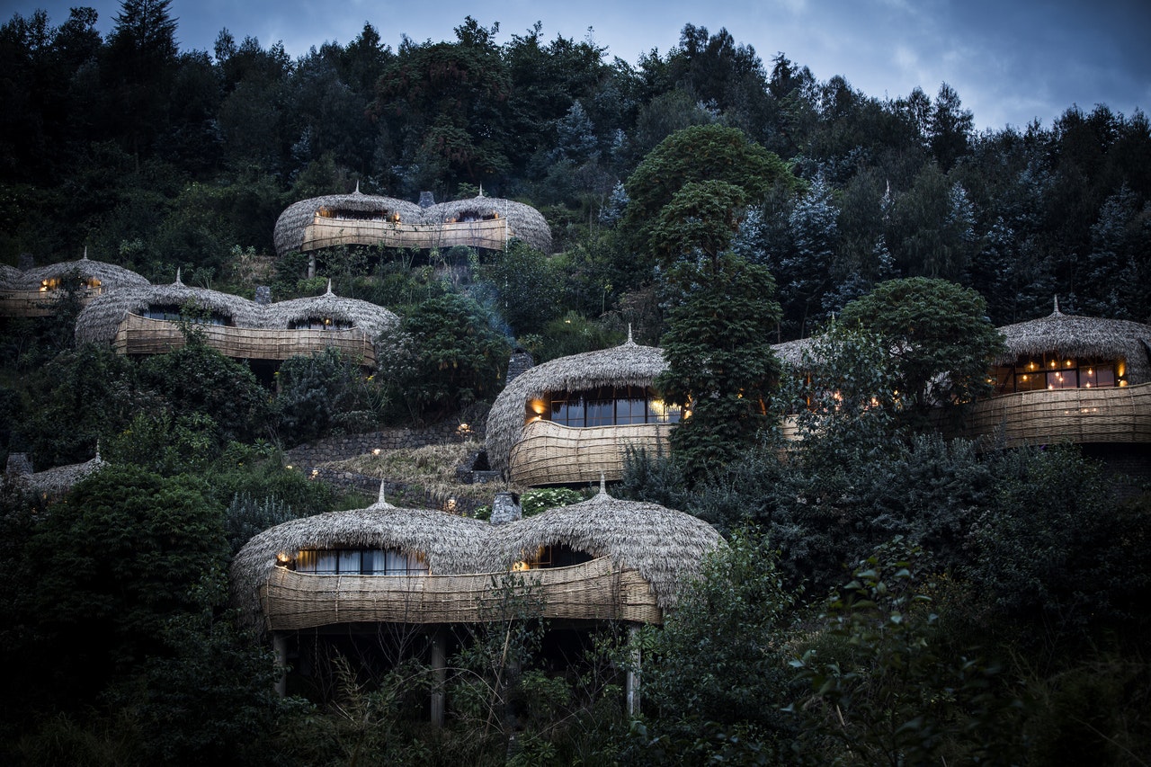 Thatched-roof huts are seen through the foliage in Rwanda.