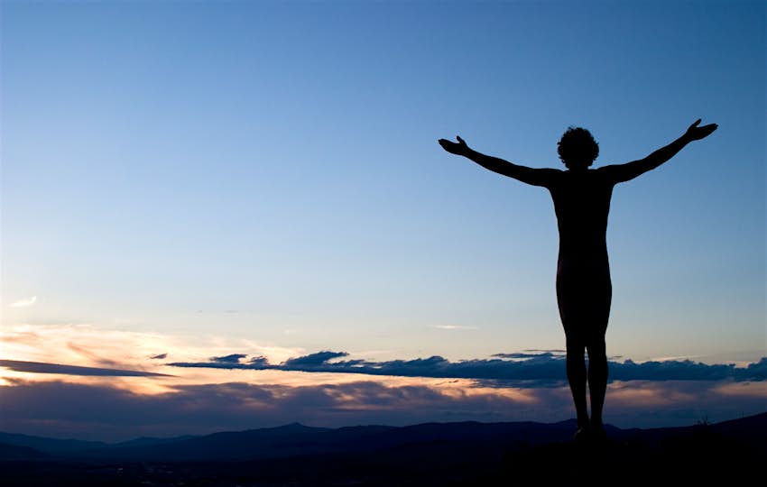 Travel News - Silhouette of Man with Arms Outstretched Towards Sky at Sunset Travel News - Silhouette of Man with Arms Outstretched Towards Sky at Sunset