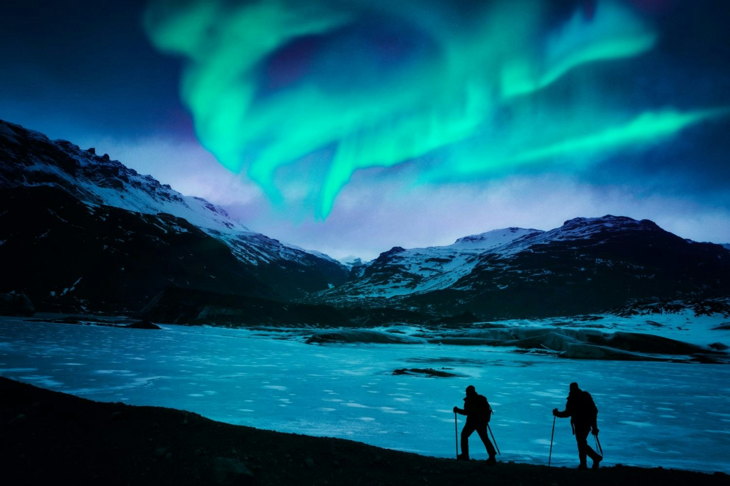 Hikers under the northern lights in Iceland