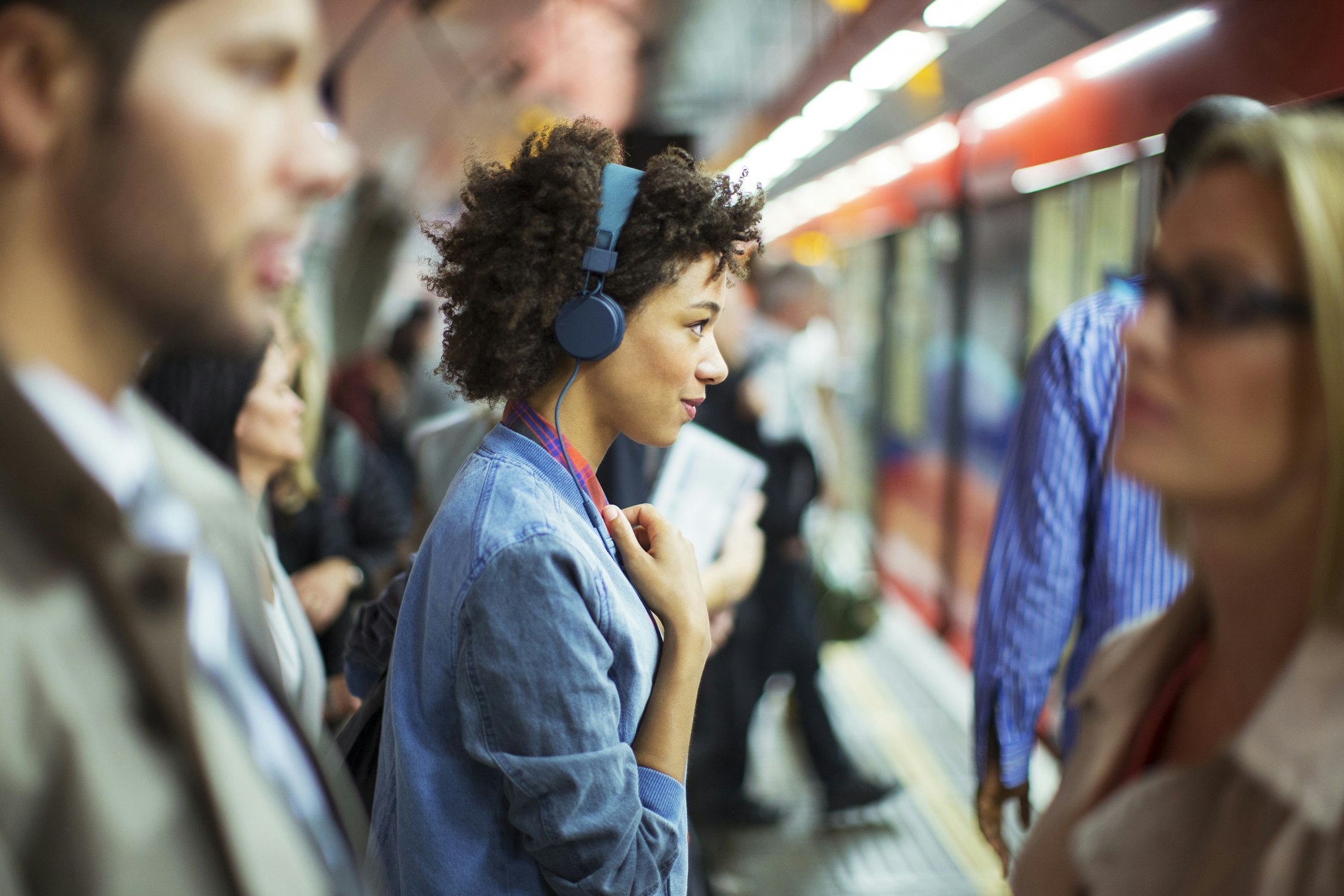 A woman listening to music on the London Tube